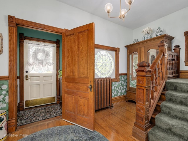 442 Du Page St, Elgin, IL 60120 - foyer entrance featuring radiator, wood finished floors, stairway, and a chandelier
