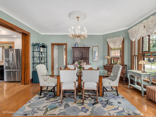 442 Du Page St, Elgin, IL 60120 - dining area featuring a chandelier, light wood-style flooring, and ornamental molding