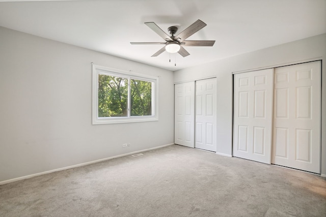 2125 Leeward Ln, Hanover Park, IL 60133 - unfurnished bedroom with multiple closets, carpet, and a ceiling fan