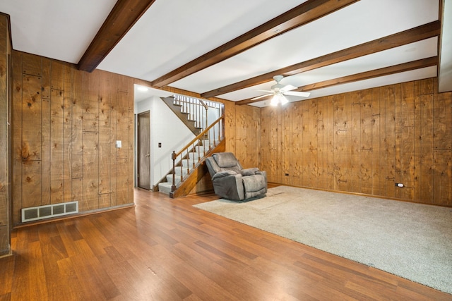 2125 Leeward Ln, Hanover Park, IL 60133 - unfurnished room featuring wood walls, beam ceiling, stairs, wood finished floors, and ceiling fan