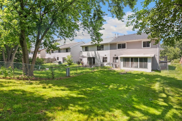2125 Leeward Ln, Hanover Park, IL 60133 - back of property with a sunroom and a fenced backyard