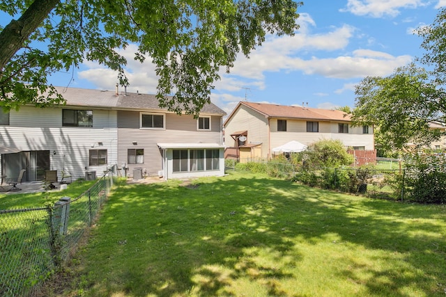 2125 Leeward Ln, Hanover Park, IL 60133 - back of house with a sunroom and a fenced backyard