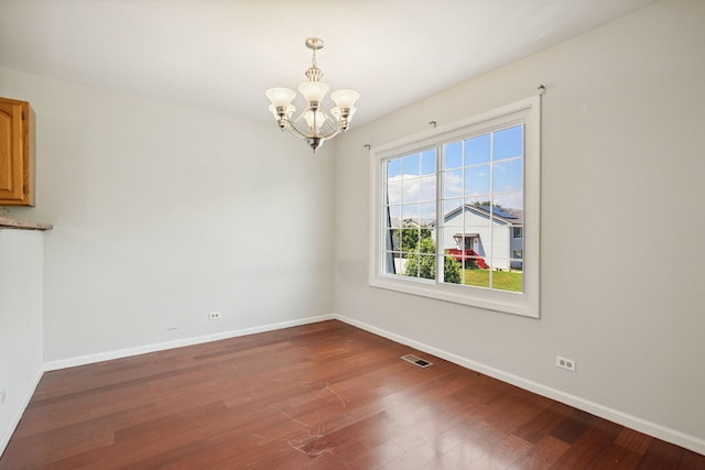 2125 Leeward Ln, Hanover Park, IL 60133 - unfurnished dining area featuring a chandelier and wood finished floors