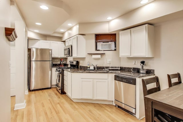 3117 N Orchard St Unit Ge, Chicago, IL 60657 - kitchen with appliances with stainless steel finishes, light wood-style flooring, dark stone countertops, recessed lighting, and white cabinets