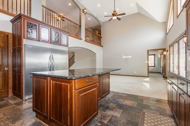 8741 W Blackthorne Way, Frankfort, IL 60423 - kitchen with built in refrigerator, arched walkways, ceiling fan, a kitchen island, and stone tile flooring