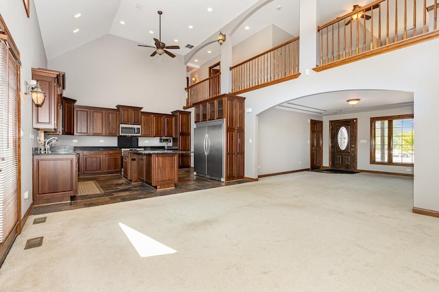 8741 W Blackthorne Way, Frankfort, IL 60423 - kitchen with stainless steel appliances, open floor plan, arched walkways, high vaulted ceiling, and dark countertops