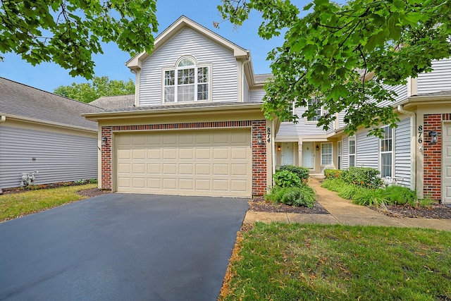 874 Dandridge Ct, Elgin, IL 60120 - traditional-style house featuring brick siding, asphalt driveway, and a garage