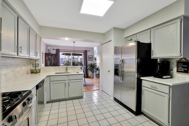 874 Dandridge Ct, Elgin, IL 60120 - kitchen featuring stainless steel appliances, light tile patterned floors, backsplash, light countertops, and a peninsula