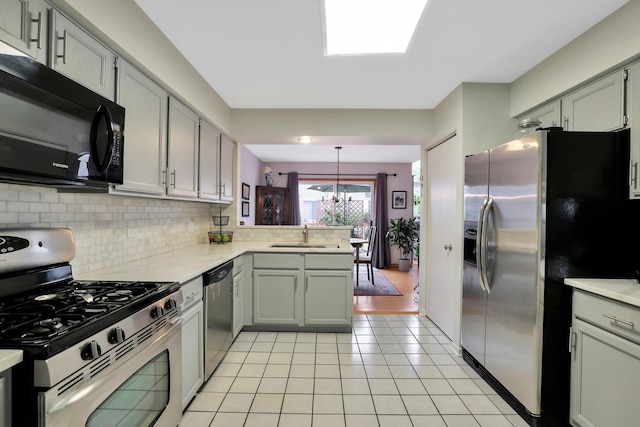 874 Dandridge Ct, Elgin, IL 60120 - kitchen with stainless steel appliances, light tile patterned floors, light countertops, and backsplash