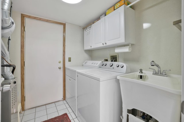 874 Dandridge Ct, Elgin, IL 60120 - washroom featuring washing machine and clothes dryer, cabinet space, and light tile patterned floors