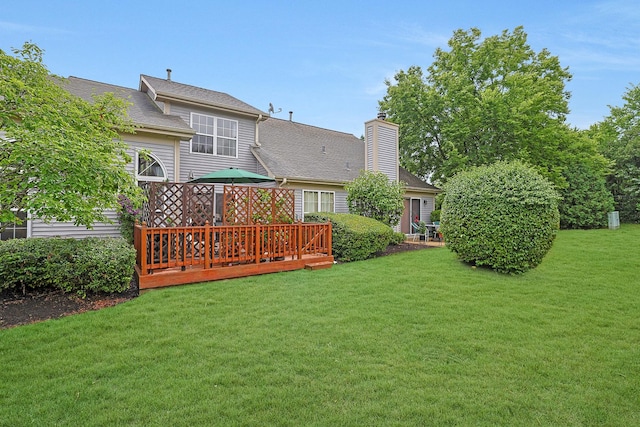 874 Dandridge Ct, Elgin, IL 60120 - back of property with a yard, a wooden deck, a chimney, and roof with shingles
