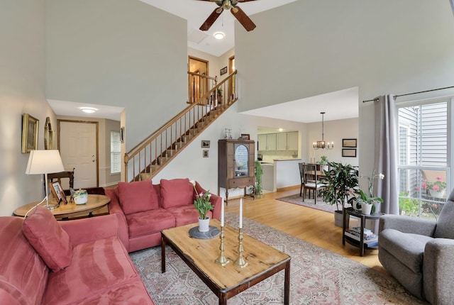 874 Dandridge Ct, Elgin, IL 60120 - living area with a towering ceiling, stairs, ceiling fan, wood finished floors, and a chandelier