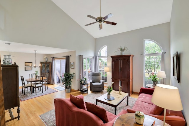 874 Dandridge Ct, Elgin, IL 60120 - living area with high vaulted ceiling, ceiling fan, light wood-type flooring, and a chandelier