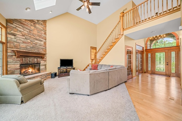 772 Wild Ginger Rd, Sugar Grove, IL 60554 - living room featuring high vaulted ceiling, a skylight, ceiling fan, stairway, and a fireplace