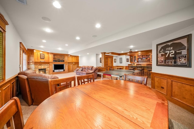 772 Wild Ginger Rd, Sugar Grove, IL 60554 - dining area featuring wainscoting, a stone fireplace, a decorative wall, recessed lighting, and built in shelves