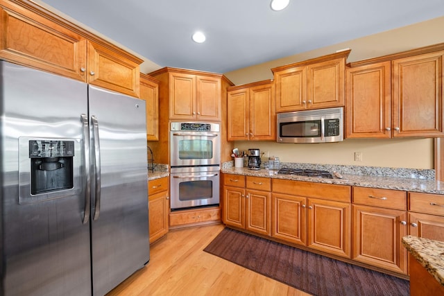 772 Wild Ginger Rd, Sugar Grove, IL 60554 - kitchen with stainless steel appliances, light wood-style floors, recessed lighting, light stone counters, and brown cabinets