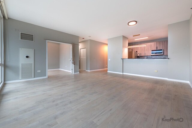 757 N Orleans St Unit 1104, Chicago, IL 60654 - unfurnished living room featuring light wood-style floors and baseboards