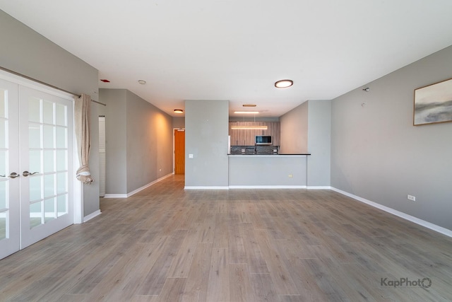 757 N Orleans St Unit 1104, Chicago, IL 60654 - unfurnished living room featuring wood finished floors and baseboards