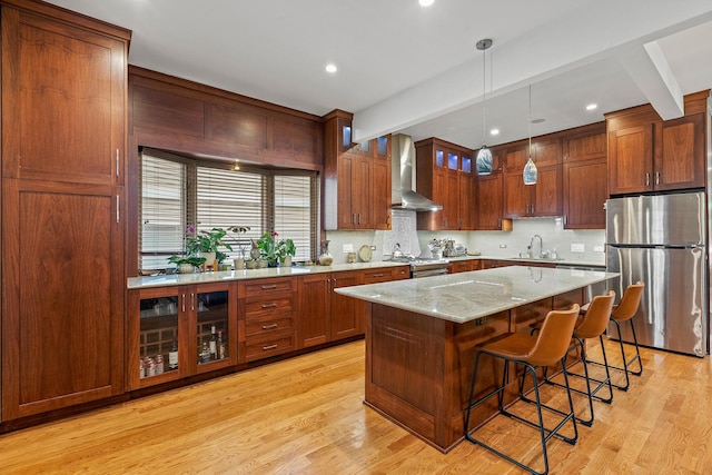 4317 N Kenneth Ave, Chicago, IL 60641 - kitchen featuring appliances with stainless steel finishes, wall chimney range hood, tasteful backsplash, light wood-style floors, and beam ceiling