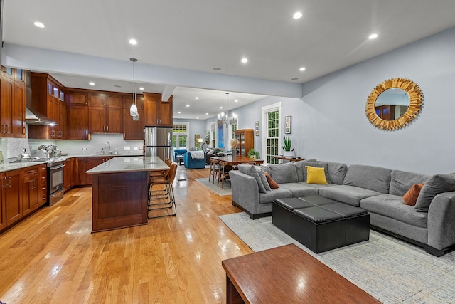 4317 N Kenneth Ave, Chicago, IL 60641 - living area with light wood finished floors, recessed lighting, and a chandelier