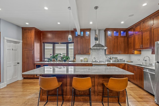 4317 N Kenneth Ave, Chicago, IL 60641 - kitchen featuring stainless steel appliances, wall chimney range hood, tasteful backsplash, light stone counters, and glass insert cabinets