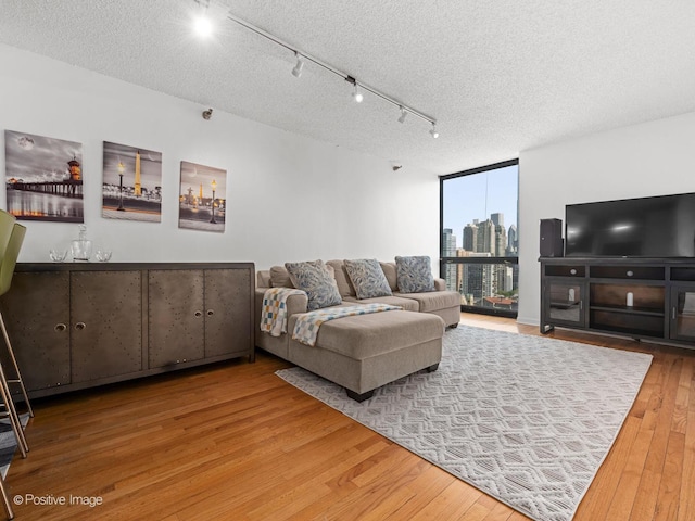 1122 N Clark St Unit 2609, Chicago, IL 60610 - living room featuring hardwood / wood-style flooring, expansive windows, and a textured ceiling