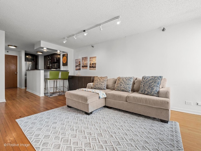 1122 N Clark St Unit 2609, Chicago, IL 60610 - living area with hardwood / wood-style floors, a textured ceiling, and bar