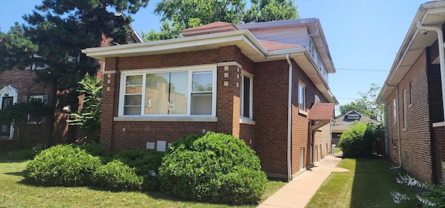 9325 S Loomis St, Chicago, IL 60620 - view of side of property with brick siding and a yard