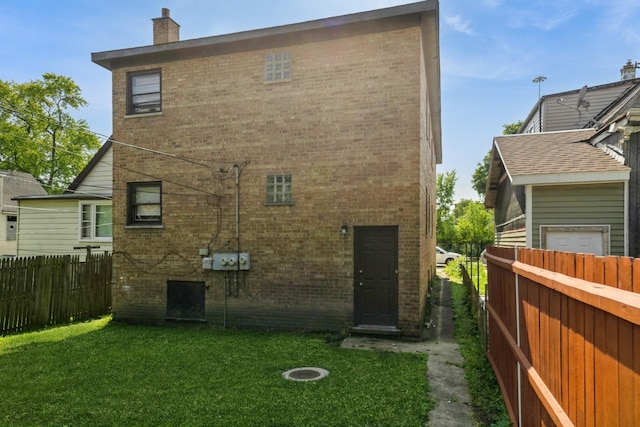 5623 S Hamilton Ave, Chicago, IL 60636 - rear view of property featuring brick siding and a chimney