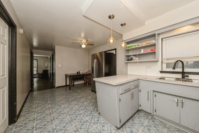 5623 S Hamilton Ave, Chicago, IL 60636 - kitchen featuring stainless steel fridge, ceiling fan, light countertops, open shelves, and a peninsula