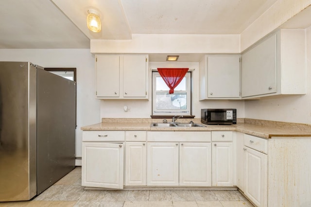 5623 S Hamilton Ave, Chicago, IL 60636 - kitchen with freestanding refrigerator, light countertops, and white cabinetry