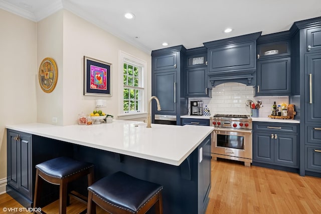 641 Highview Ter, Lake Forest, IL 60045 - kitchen with luxury stove, a breakfast bar, crown molding, a peninsula, and light countertops
