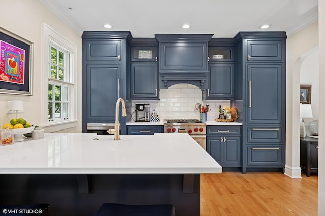 641 Highview Ter, Lake Forest, IL 60045 - kitchen featuring designer stove, crown molding, light countertops, arched walkways, and decorative backsplash