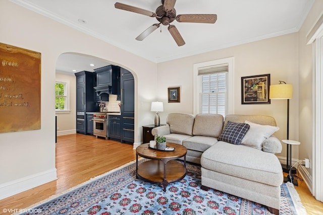 641 Highview Ter, Lake Forest, IL 60045 - living room featuring arched walkways, light wood finished floors, crown molding, and a ceiling fan