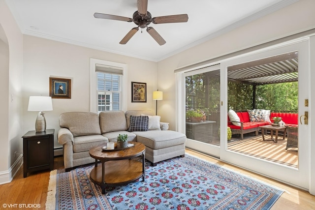 641 Highview Ter, Lake Forest, IL 60045 - living room featuring light wood finished floors, ceiling fan, crown molding, arched walkways, and a baseboard heating unit