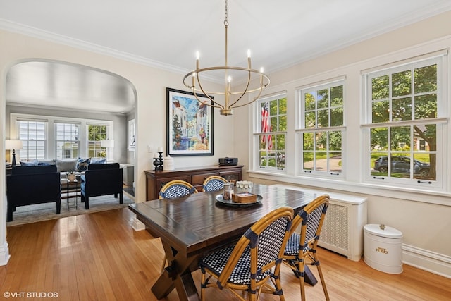 641 Highview Ter, Lake Forest, IL 60045 - dining space featuring arched walkways, radiator heating unit, a chandelier, light wood-type flooring, and crown molding