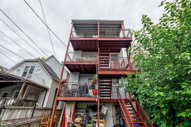 2832 N Mozart St, Chicago, IL 60618 - rear view of property with stairway, brick siding, and a balcony
