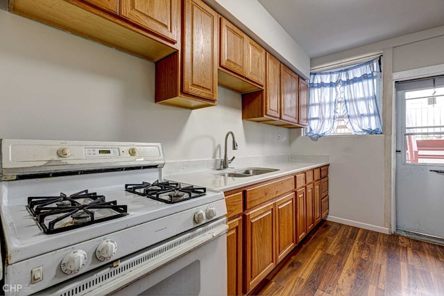 2832 N Mozart St, Chicago, IL 60618 - kitchen featuring white range with gas stovetop, dark wood-type flooring, light countertops, and brown cabinets