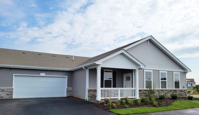 1075 Savannah Ln, Pingree Grove, IL 60140 - view of front of property featuring stone siding, a porch, driveway, and a garage