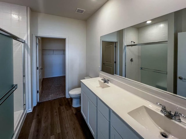 1075 Savannah Ln, Pingree Grove, IL 60140 - bathroom with a stall shower, wood finished floors, a walk in closet, and double vanity