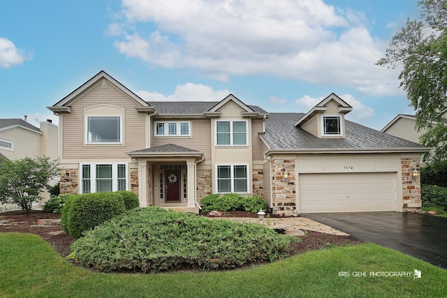 1312 Mulberry Ln, Cary, IL 60013 - traditional home with stone siding, asphalt driveway, a shingled roof, and an attached garage