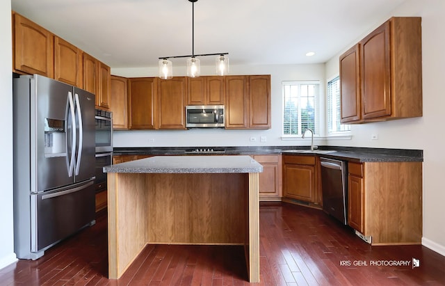 1312 Mulberry Ln, Cary, IL 60013 - kitchen with stainless steel appliances, dark wood-style floors, dark countertops, a kitchen island, and recessed lighting