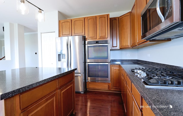 1312 Mulberry Ln, Cary, IL 60013 - kitchen featuring stainless steel appliances, dark wood finished floors, brown cabinets, and ornamental molding