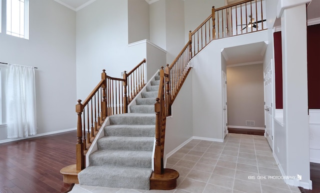 1312 Mulberry Ln, Cary, IL 60013 - staircase with a towering ceiling, wood finished floors, and crown molding