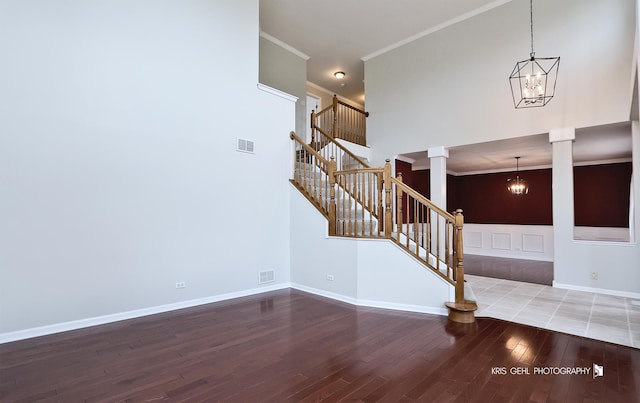 1312 Mulberry Ln, Cary, IL 60013 - foyer entrance featuring a chandelier, wood finished floors, stairway, ornamental molding, and ornate columns