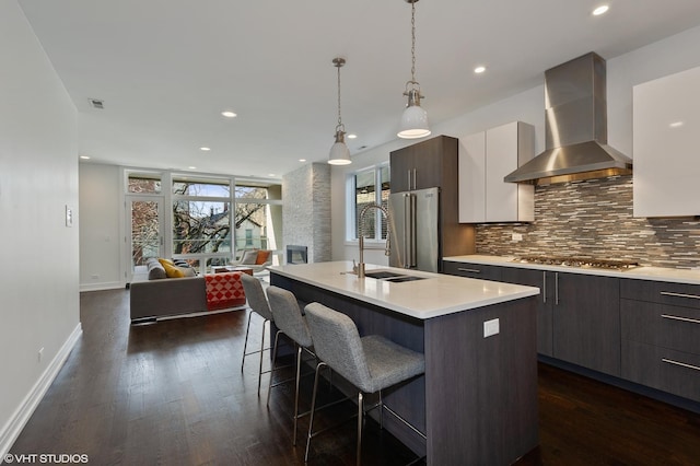 1522 W Huron St Unit 2W, Chicago, IL 60642 - kitchen with wall chimney range hood, stainless steel appliances, modern cabinets, light countertops, and backsplash