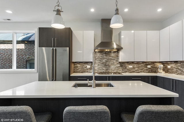 1522 W Huron St Unit 2W, Chicago, IL 60642 - kitchen featuring wall chimney exhaust hood, appliances with stainless steel finishes, modern cabinets, light countertops, and a kitchen bar