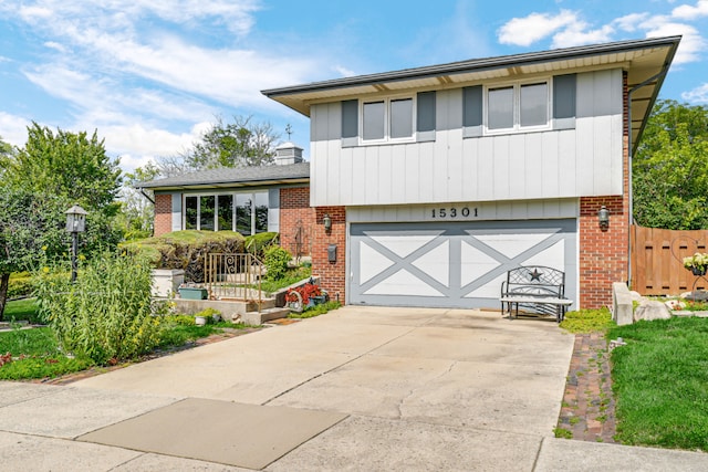 15301 Cherry Ln, Oak Forest, IL 60452 - split level home featuring brick siding, a garage, and driveway