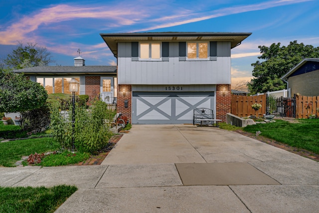 15301 Cherry Ln, Oak Forest, IL 60452 - tri-level home with brick siding, driveway, and an attached garage