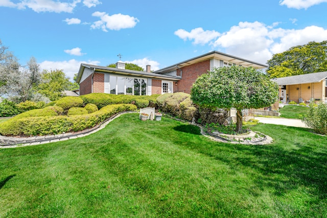 15301 Cherry Ln, Oak Forest, IL 60452 - back of house with brick siding, a chimney, and a yard